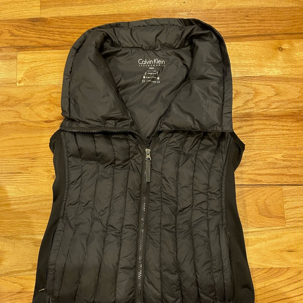 Calvin Klein performance vest.Premium down. Zip secure pocket,headphone access.